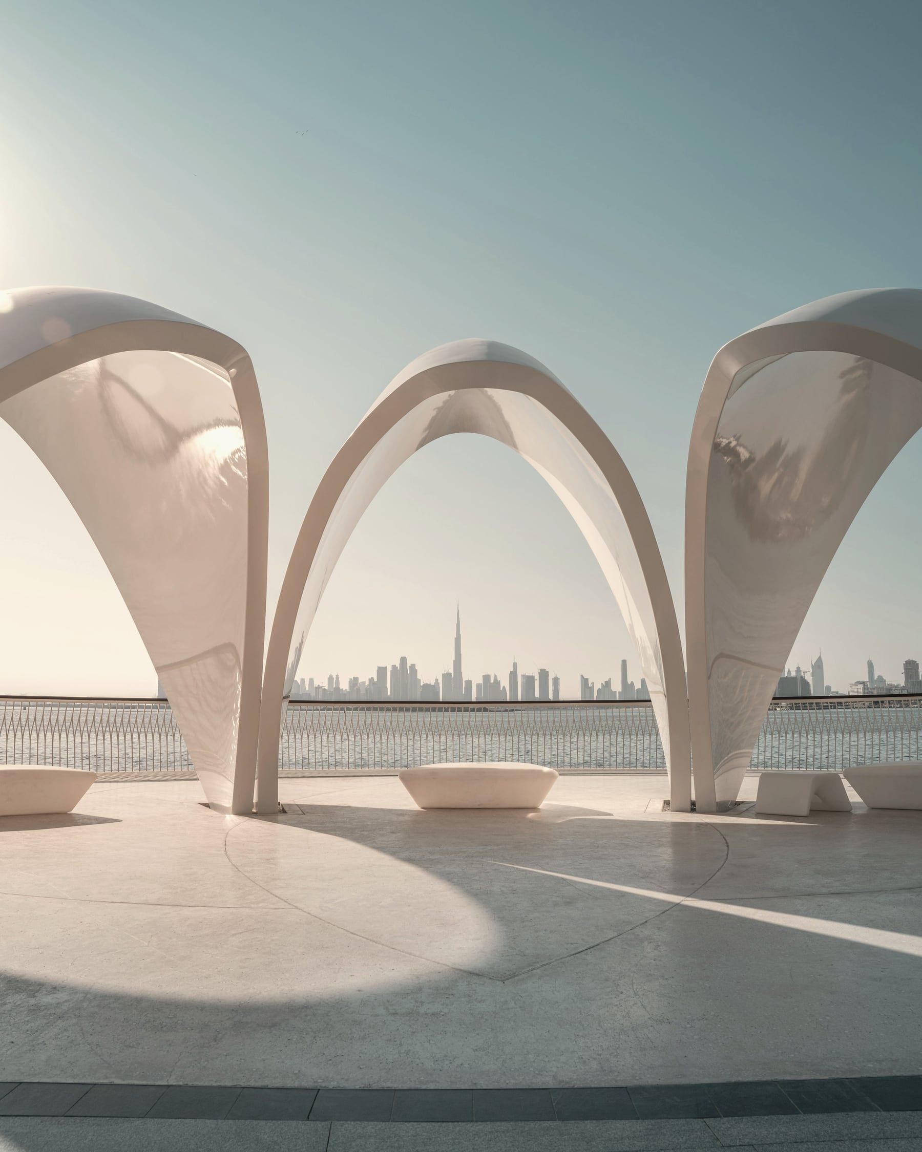 White arches with the Dubai skyline in the distance